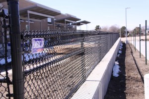 Perspective view of a 4' black chain link fence.