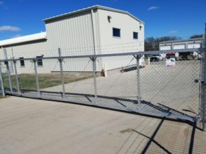 Aluminum cantilever gate. Kearney fence company commercial fence contractors Kearney, Nebraska double single cantilever roller slide vertical lift vertical pivot oramental picket decorative chain link security commercial industrial correctional prison manufacturing hinges hardware swing drive way estate perimeter 