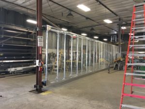 photo of metal gate in fabrication area. commercial gates Kearney, Nebraska fence company fencing contractors double single cantilever roller slide vertical lift vertical pivot oramental picket decorative chain link security commercial industrial correctional prison manufacturing hinges hardware swing drive way estate perimeter 
