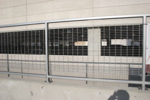 Side view of railing with bar grate mesh panels. welded wire mesh square welded wire mesh  woven wire crimped wire ¼” 1/8” 4 6 9 10 11 14 gauge architectural mechanical screening screen louvered semi private private solid staggered board on board shadow box alternating industrial louvers rooftop louvers chillers generators truck wells outside storage condensers rooftop equipment patios trash dumpsters transformers HVAC courtyards pool equipment fence aluminum galvanized steel degree of openness direct visibility standalone wall louvers  green screen trellis screen plant screen