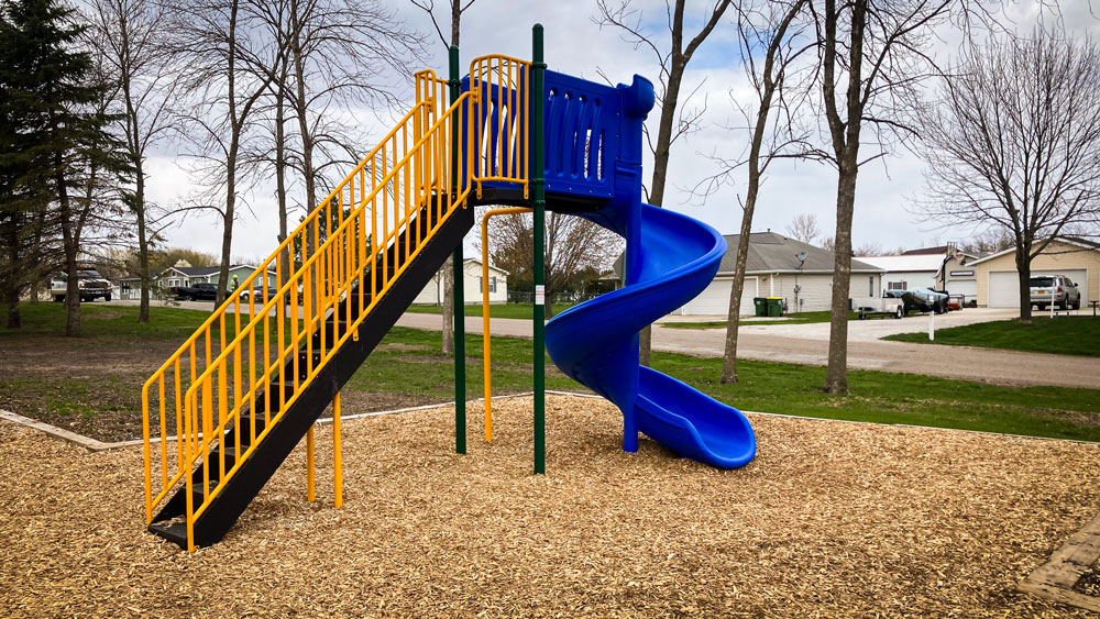 Blue slide with stairs and top platform. Playground company Kearney, Nebraska playground installation playground equipment slides swings surfacing climbers children recreation safety durable