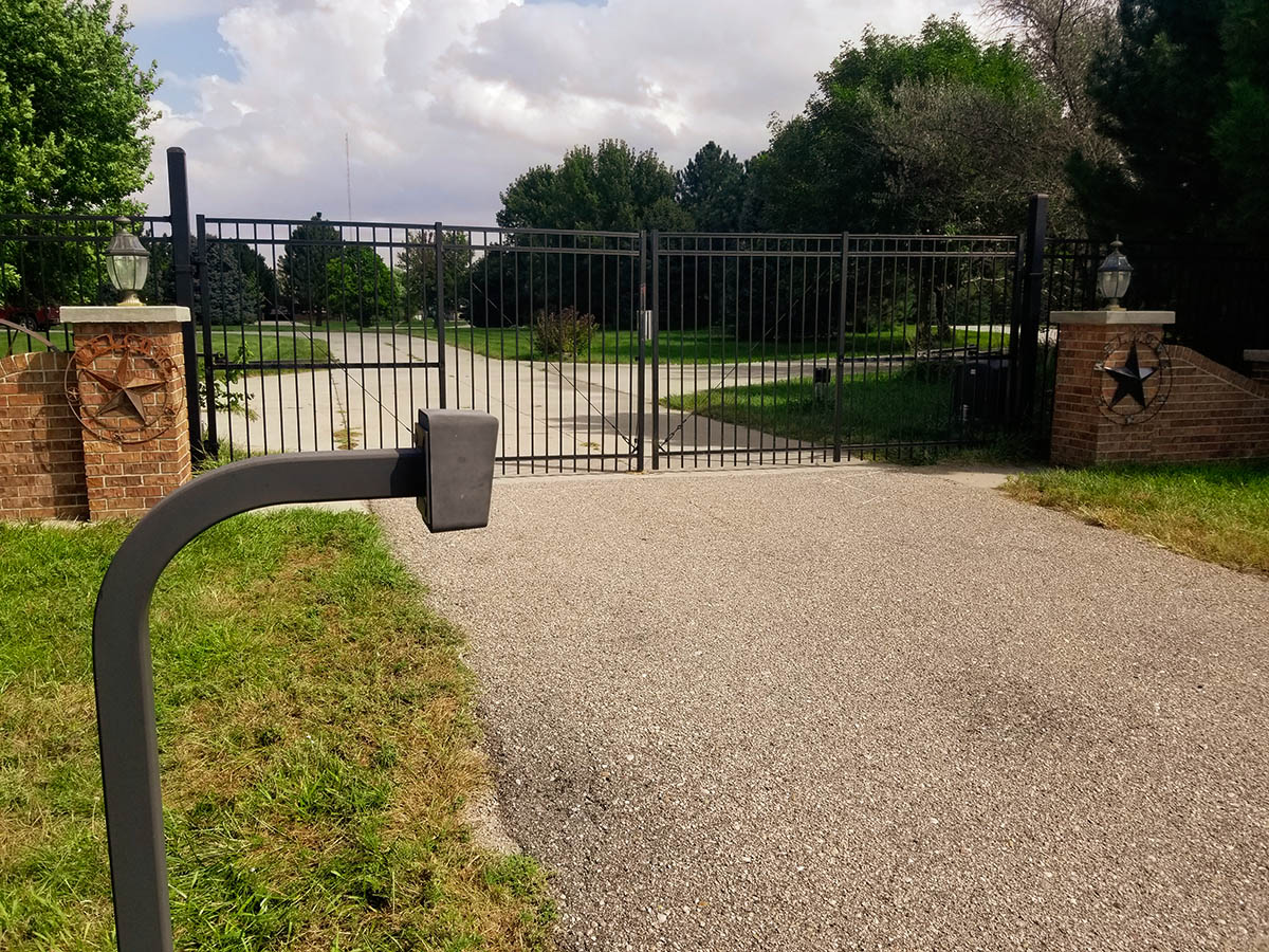 Black ornamental picket style double swing gate with access control pad. Kearney fence company fence contractors Nebraska gates automation residential commercial