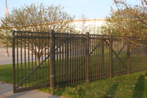 bronze colored, ornamental closed picket cantilever gate