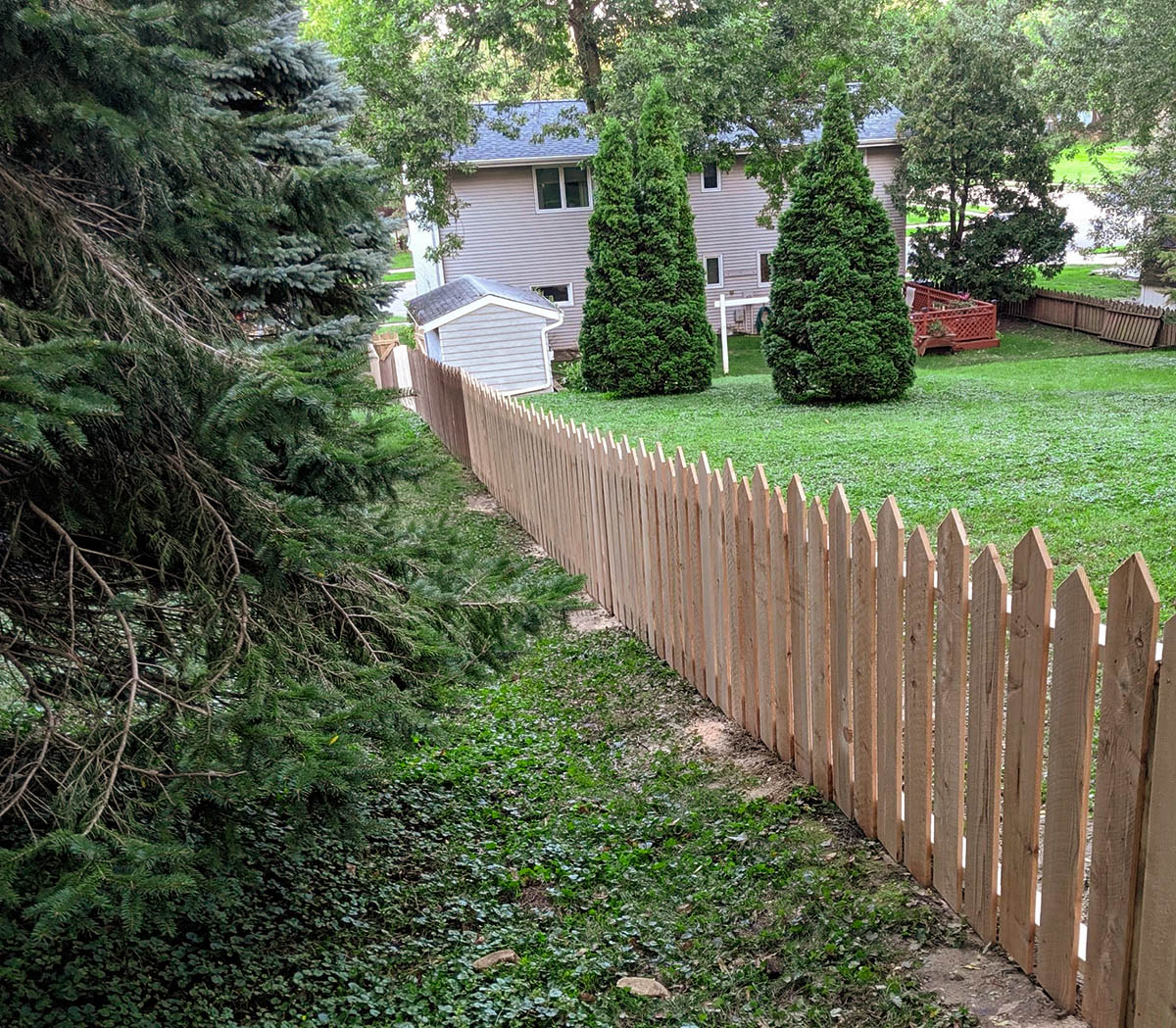 Wood picket fence with alternating picket heights in Kearney